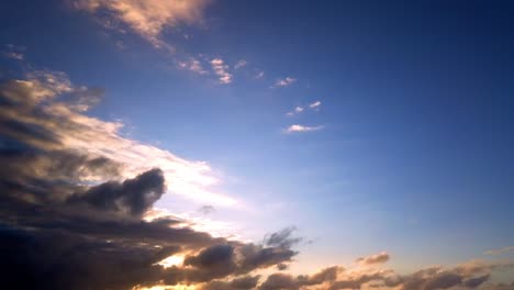 Fire-sunset-and-sunrise-cloud-time-lapse-footage-of-the-colorful-sky-with-fluffy-clouds-and-jet-airplane-passing-by-above-silhouettes-of-dark-clouds-at-the-time-of-dusk