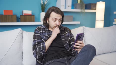 he is shocked by what is happening on the phone.