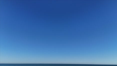 drone shot of sky tilting down to reveal lake ontario