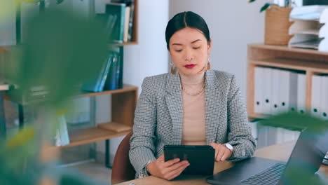 asian, tablet and business woman typing in office