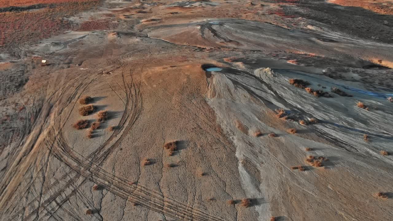 Tracks left on a dry landscape in Georgia during the afternoon sun