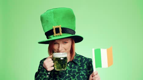 happy woman with irish flag drinking beer