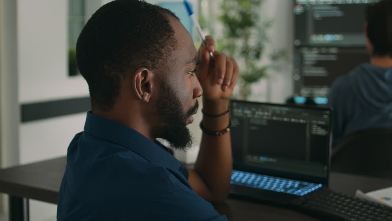 Software programer brainstorming ideas to write code and create security program