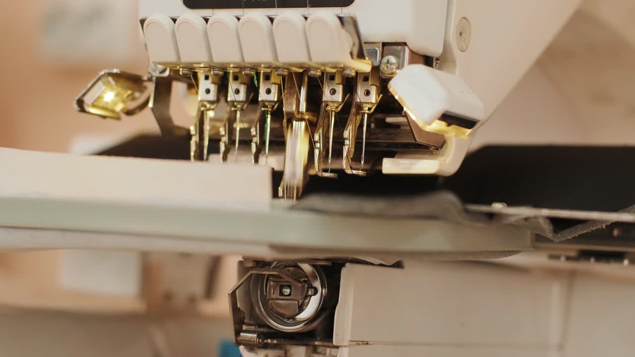 The automatic embroidery machine is working at high speed. Close-up