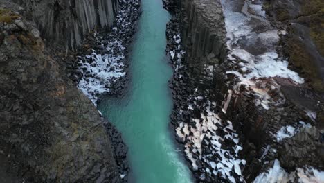 high angle aerial over stuðlagil canyon in winter