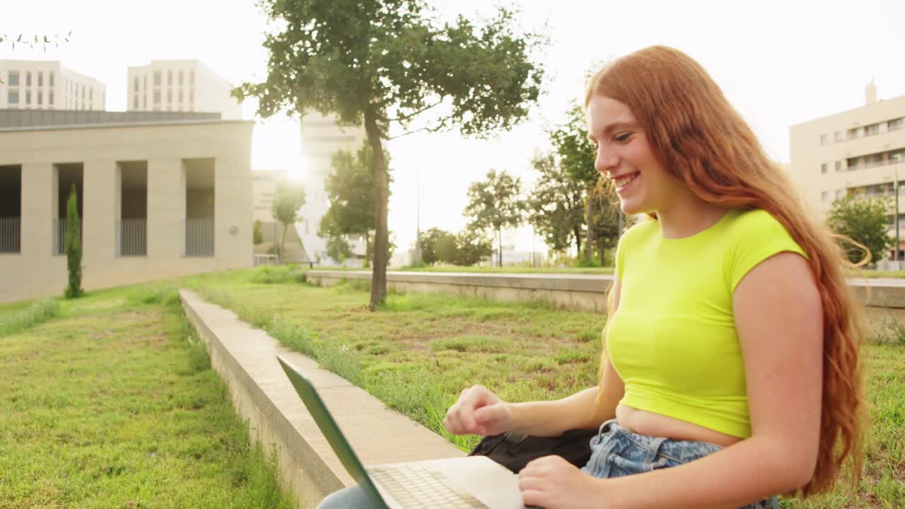 Woman using laptop in park