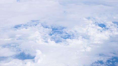 Different-layers-white-and-grey-clouds-together-in-blue-sky,-natural-weather-atmosphere-pattern,-high-view-from-plane