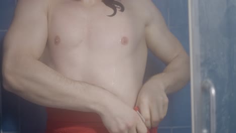 man drying off in a shower
