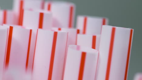 macro close-up, a bunch of red and white single-use plastic straws