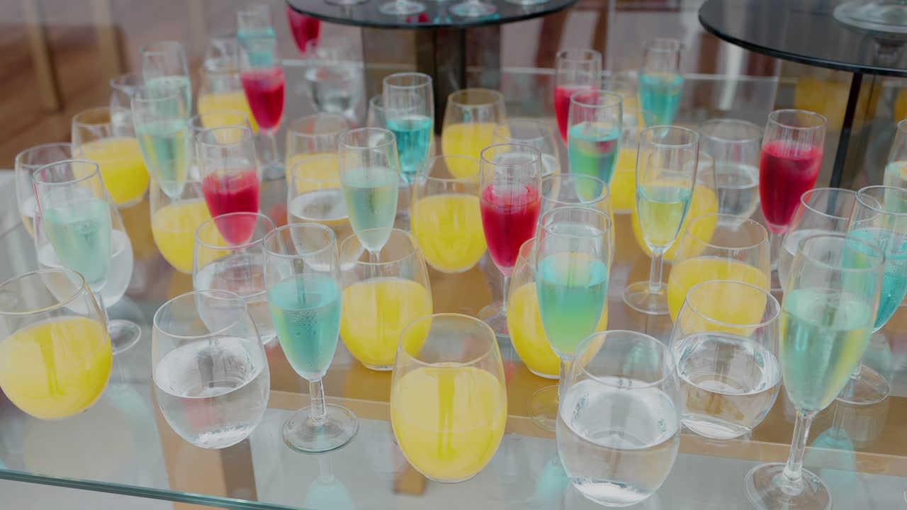 vibrant red yellow blue beverages on a reflective surface at event