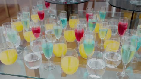 vibrant red yellow blue beverages on a reflective surface at event