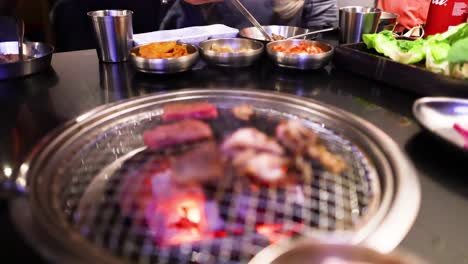 grilling meat at a korean bbq restaurant