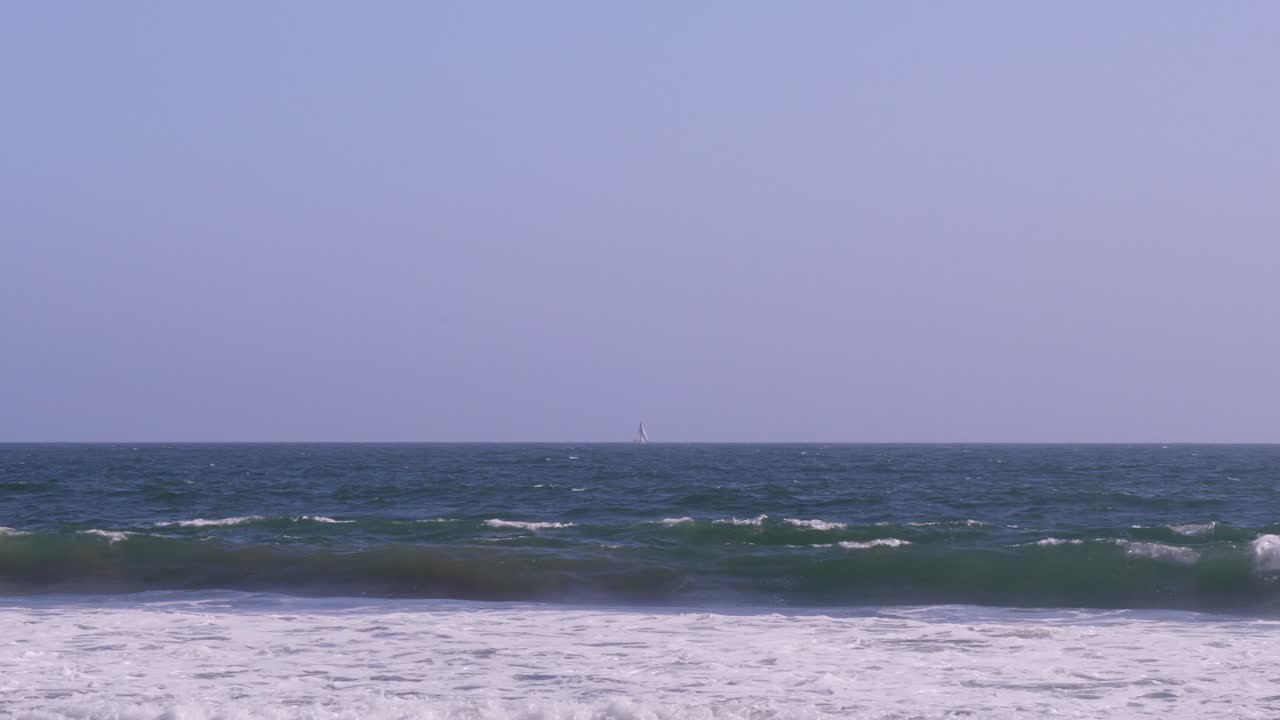 밝고 화창한 날 왼쪽에서 오른쪽으로 패닝하는 바다에서 외로운 범선의 패닝 샷