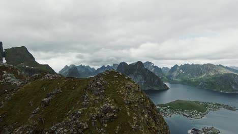 majestic view of reinebringen region in norway on cloudy day, fpv drone fly view