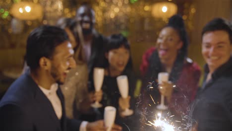 high angle shot of a group of friends celebrating new years eve with champagne sparklers