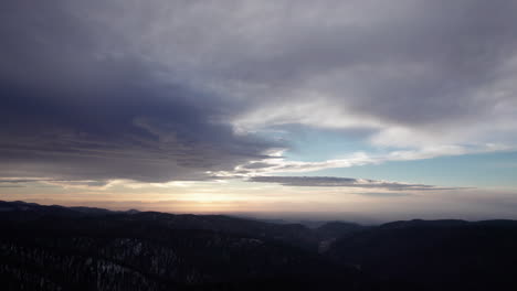 aerial-view-of-dramatic-sunset-clouds-over-forest-covered-mountains-near-Cloudcroft,-New-Mexico