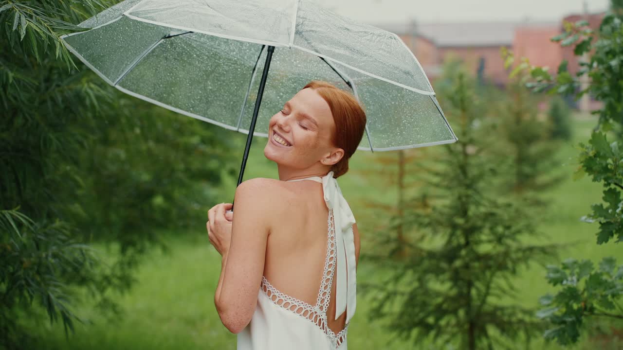 Woman under a transparent umbrella in the rain