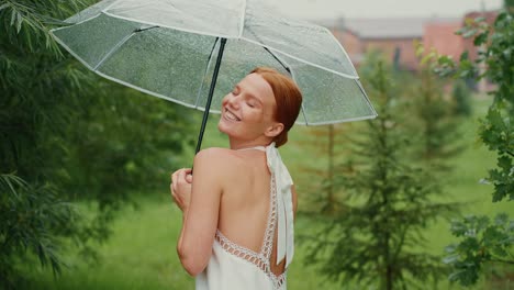 woman under a transparent umbrella in the rain