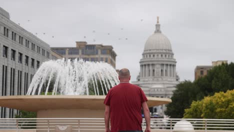 man walking away from camera at menona terrace in madison, wisconsin