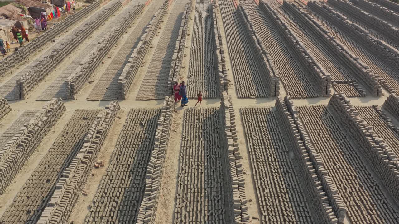 Aerial footage of traditional brick making with drying bricks in Bangladesh