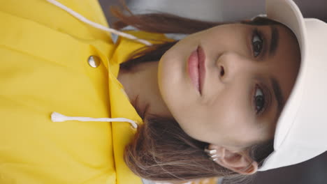 woman in yellow raincoat and white cap