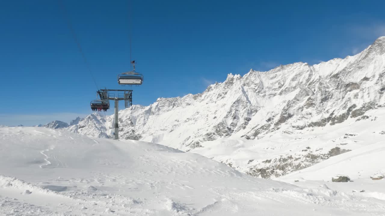 Wide of ski chair lift with tourists in mountain range panorama background