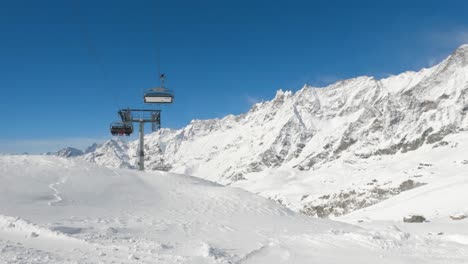 wide of ski chair lift with tourists in mountain range panorama background
