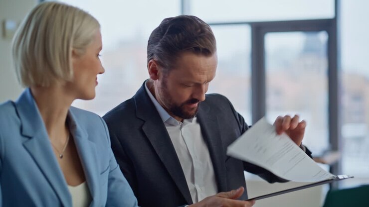 Businesspeople greeting virtual meeting waving hand to laptop in cabinet closeup