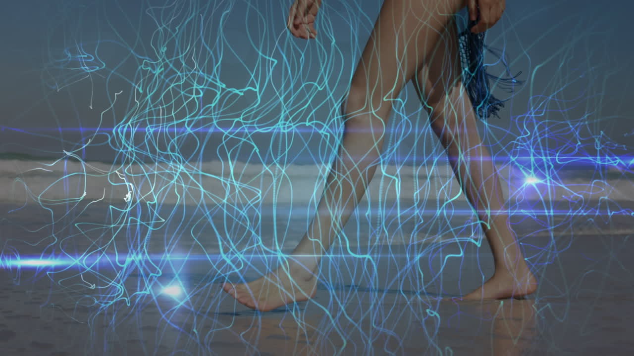 Animation of light trails over caucasian woman walking at beach