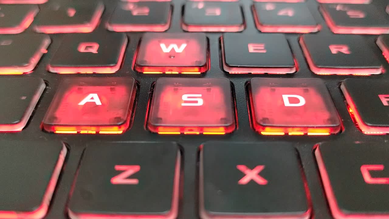 Red backlit gaming laptop keyboard. Perfect for high-performance gaming setups and intense sessions.