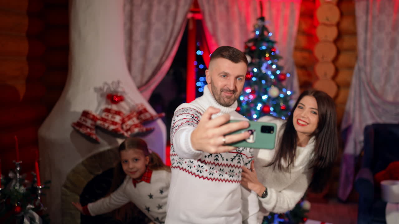 New year celebrating family selfie. Cheerful smiling young family xmas holidays.