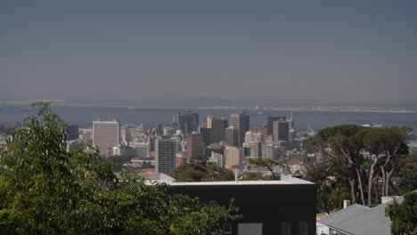 cape town city centre as seen from the hills of the surrounding suburbs. in the background we can feel the atlantic ocean and harbour