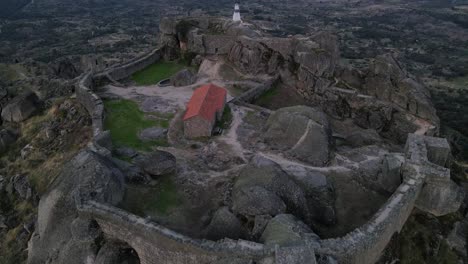 Drone-view-of-the-Monsanto-Castle-area-with-specific-focus-on-the-horizon-where-the-land-and-the-sky-meets