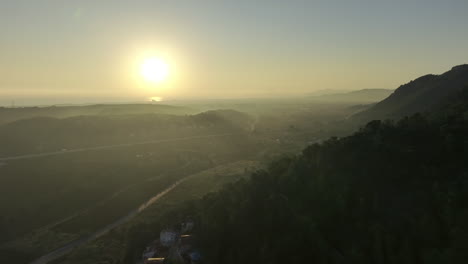 sunrise over coastal mountains and village