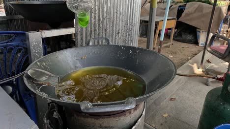 sequence of oil being poured into a wok