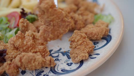 close-up of crispy fried chicken nuggets on a plate