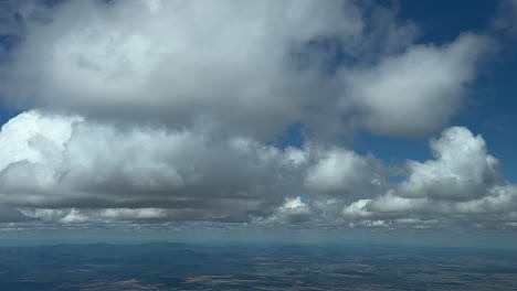 Sliding-across-a-beautiful-summer-sky-covered-with-some-tiny-fluffy-cumulus-clouds