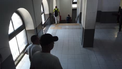 people walking up and down a staircase in a building