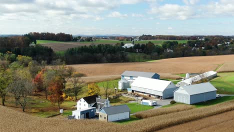 aerial orbit of american family farm in pennsylvania during autumn fall harvest season