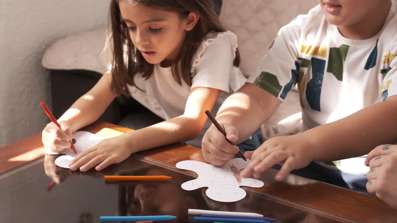 Children doing crafts at home with their mother