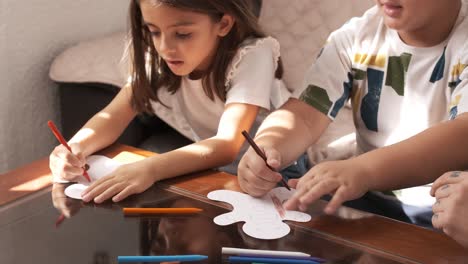 children doing crafts at home with their mother