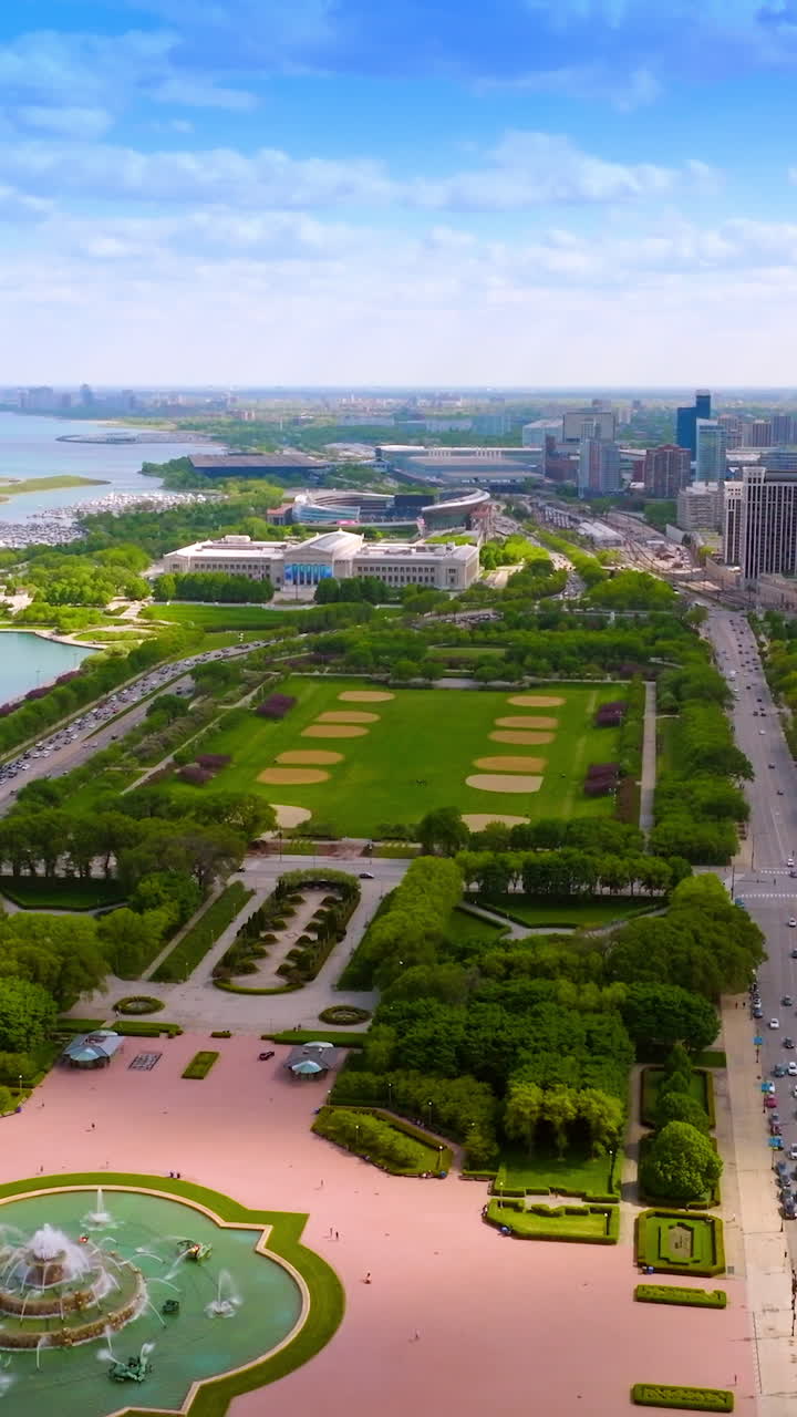 Wonderful big green park with fountain in the middle. Amazing scenery of the city at the waterfront of the lake. Vertical video