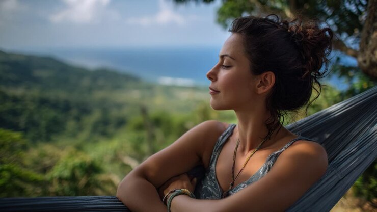 Contemplative Woman Enjoys Nature's Serenity in a Hammock Overlooking a Breathtaking Landscape with Lush Greenery and Ocean Views