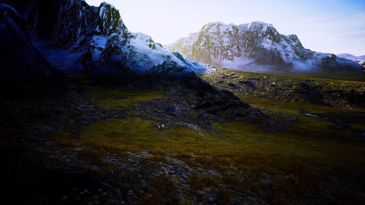 Stunning natural landscape with majestic mountains and grassy terrain at sunset