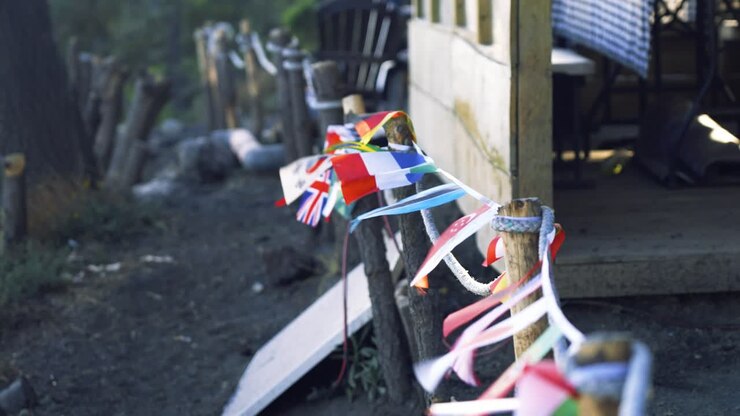 Flags of multiple countries waving in the wind at base camp, on top of Volcano Acatenango in Guatemala