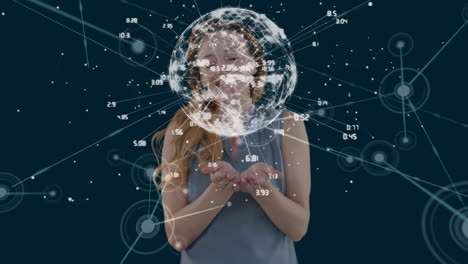 una mujer caucásica interactúa con una pantalla 3d sobre la economía global y la tecnología.