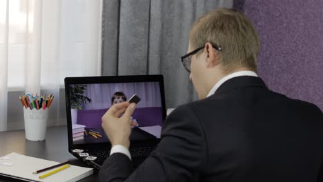 man teacher making video call on laptop with little pupil. distance education