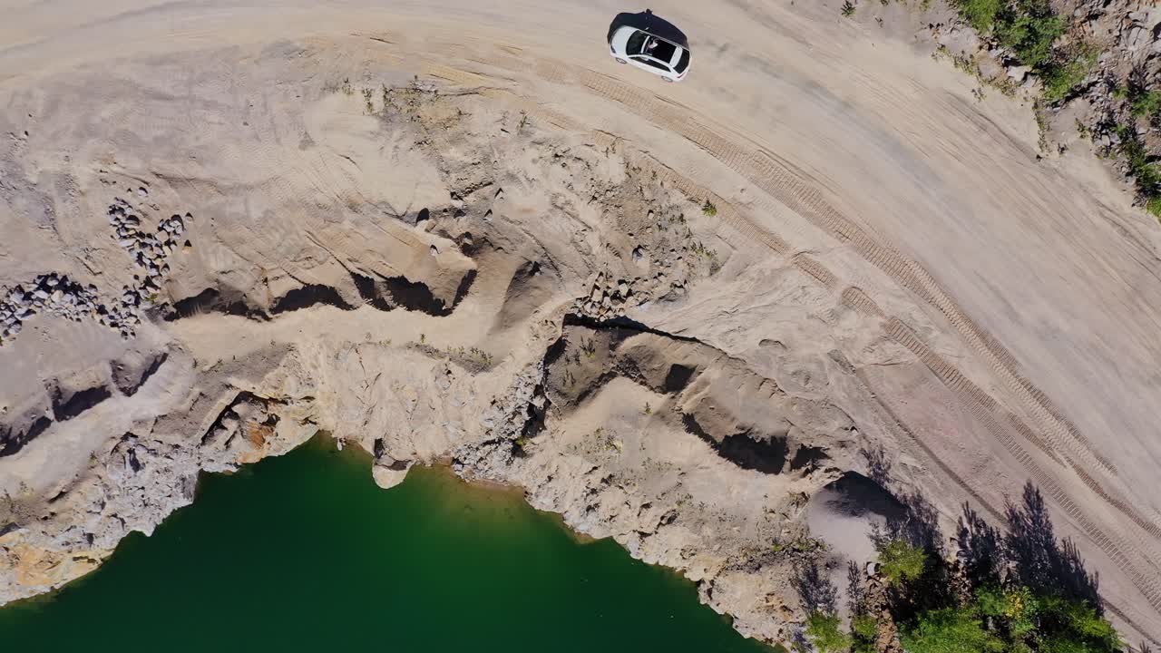 Landscape with car on mountain road. Top view of a road going near the beautiful lake in mountain