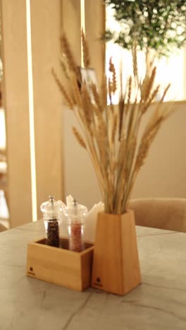 wooden tableware and dried wheat bouquet decor in a restaurant
