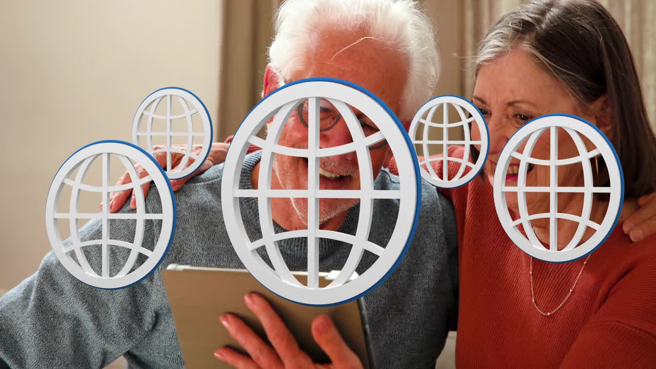 Senior couple sitting on sofa tapping tablet, activating animated globes while viewing travel app